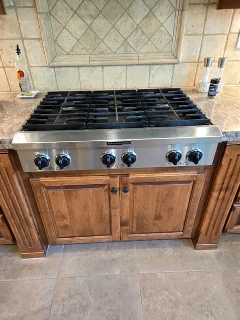 Installed KitchenAid cooktop in a residential kitchen setting, ready for use.