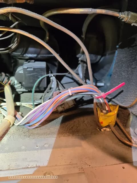 Refrigerator compressor wiring repair in progress by Luxe Appliances Repairs expert.